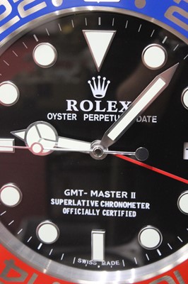 Lot 666 - A Rolex style Pepsi dial wall clock, with...