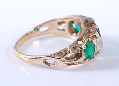 Lot 2607 - A yellow metal, emerald and diamond carved...