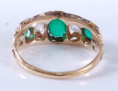 Lot 2607 - A yellow metal, emerald and diamond carved...