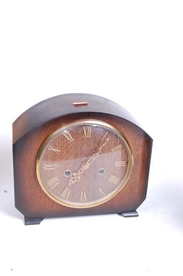 Lot 5 - A 1930s oak cased eight-day mantel clock, the...