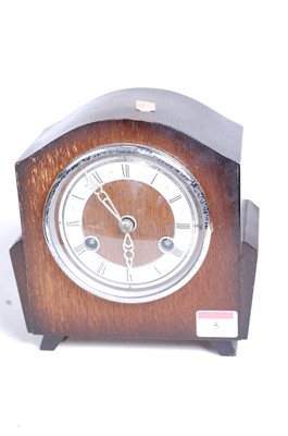 Lot 5 - A 1930s oak cased eight-day mantel clock, the...