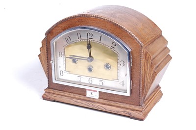 Lot 8 - A 1930s oak cased mantel clock, the eight day...