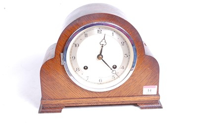 Lot 14 - A 1930s oak cased eight-day mantel clock, the...