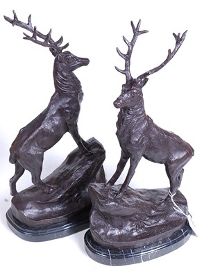 Lot 16 - A pair of bronze models of stags, each shown...