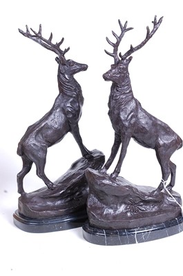 Lot 16 - A pair of bronze models of stags, each shown...