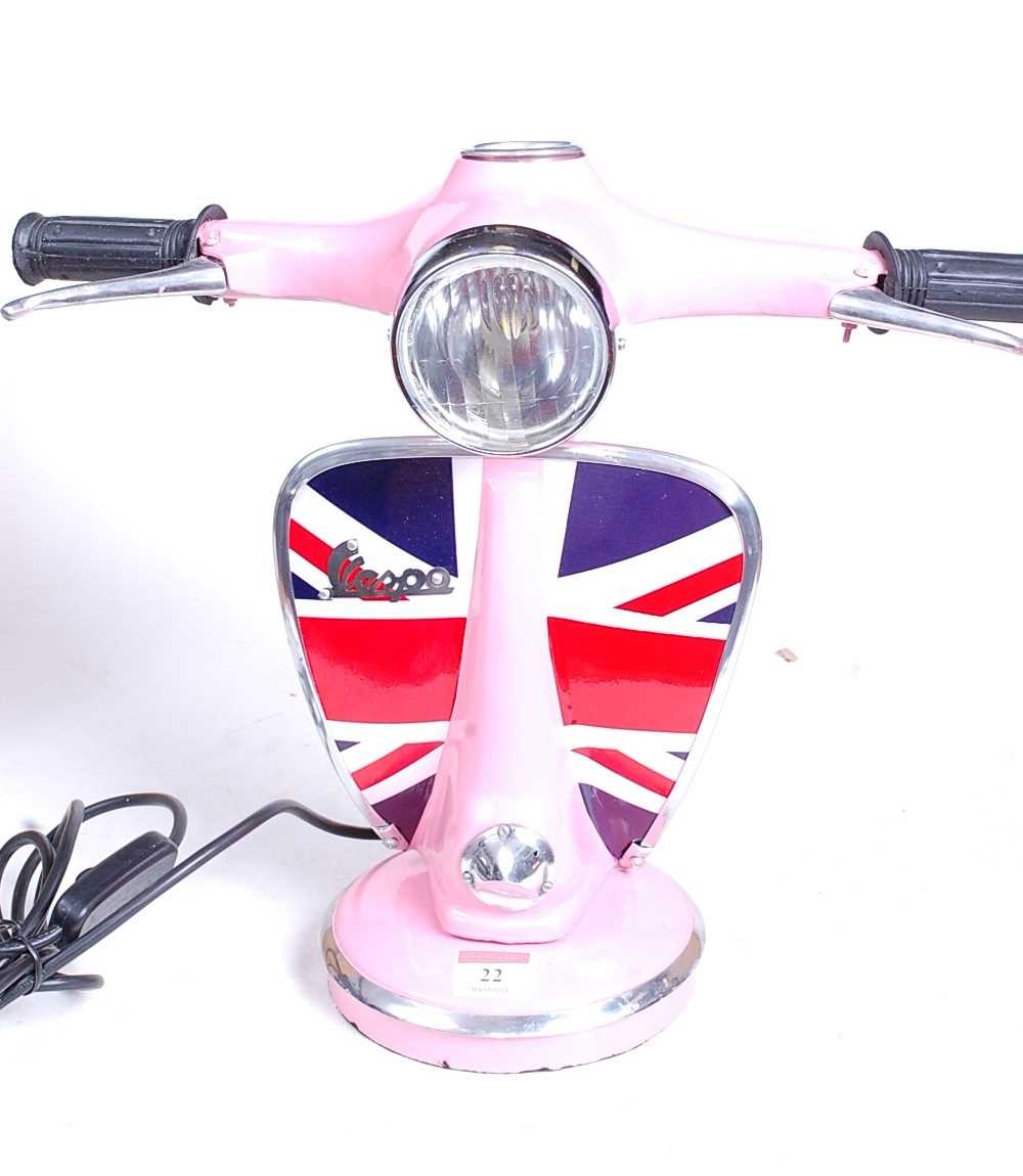 Lot 22 - A modern pink painted desk lamp in the form of...