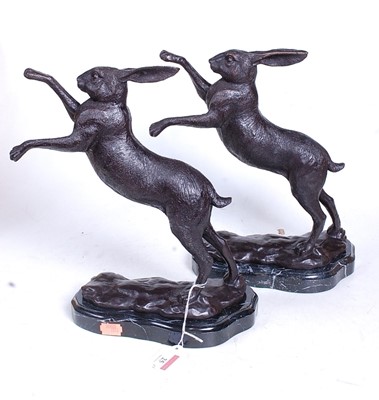 Lot 25 - A pair of bronze models of boxing hares, each...
