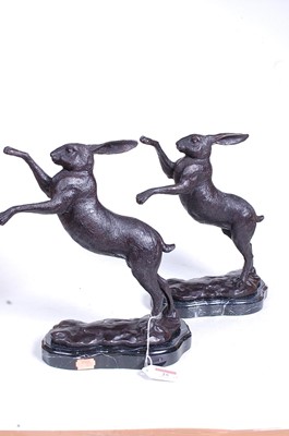 Lot 25 - A pair of bronze models of boxing hares, each...