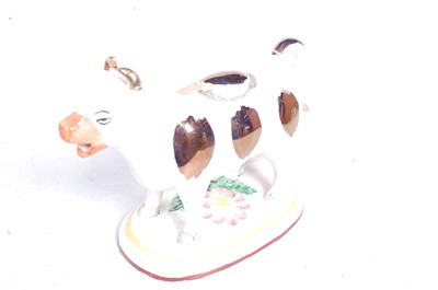 Lot 27 - A Staffordshire pottery cow creamer; together...
