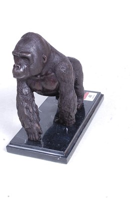 Lot 43 - A bronzed model of a gorilla, walking on all...