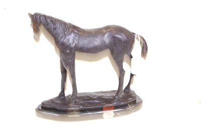 Lot 58 - A bronze model of a horse, shown in standing...