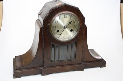 Lot 61 - A 1920s oak cased eight-day mantel clock, the...