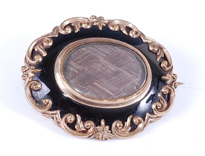 Lot 2630 - A late Victorian yellow metal oval mourning...