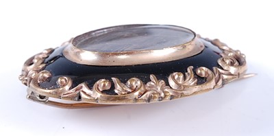 Lot 2630 - A late Victorian yellow metal oval mourning...