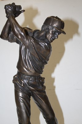 Lot 122 - A bronzed resin figure of a golfer, mounted on...