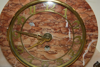 Lot 124 - A 1930s Art Deco mantel clock garniture, the...