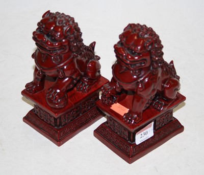 Lot 230 - A pair of reproduction resin temple lions,...
