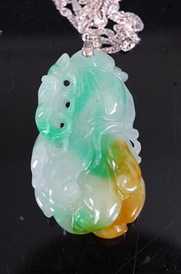 Lot 520 - A reproduction carved celadon jade pendant, on...