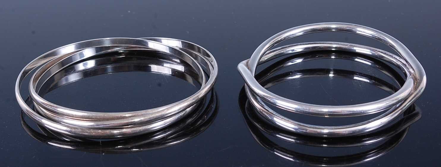 Lot 604 - A modern silver Russian style bangle, together...
