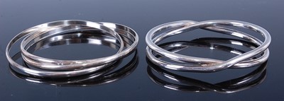 Lot 604 - A modern silver Russian style bangle, together...