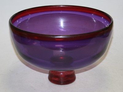Lot 210 - A 20th century purple glass fruit bowl on...