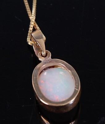 Lot 2698 - A yellow metal cabochon opal set pendant, the...