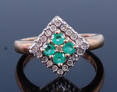 Lot 2703 - A 9ct gold emerald and diamond dress ring in...