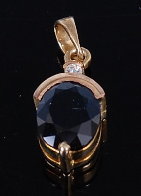 Lot 2660 - A yellow metal sapphire pendant, featuring an...