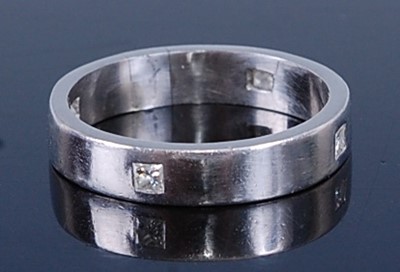 Lot 2716 - A platinum diamond set band ring, featuring...
