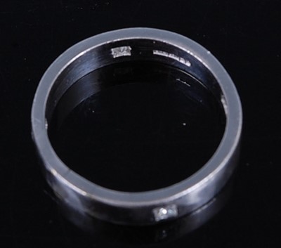 Lot 2716 - A platinum diamond set band ring, featuring...