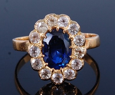 Lot 2656 - A yellow metal sapphire oval cluster ring,...