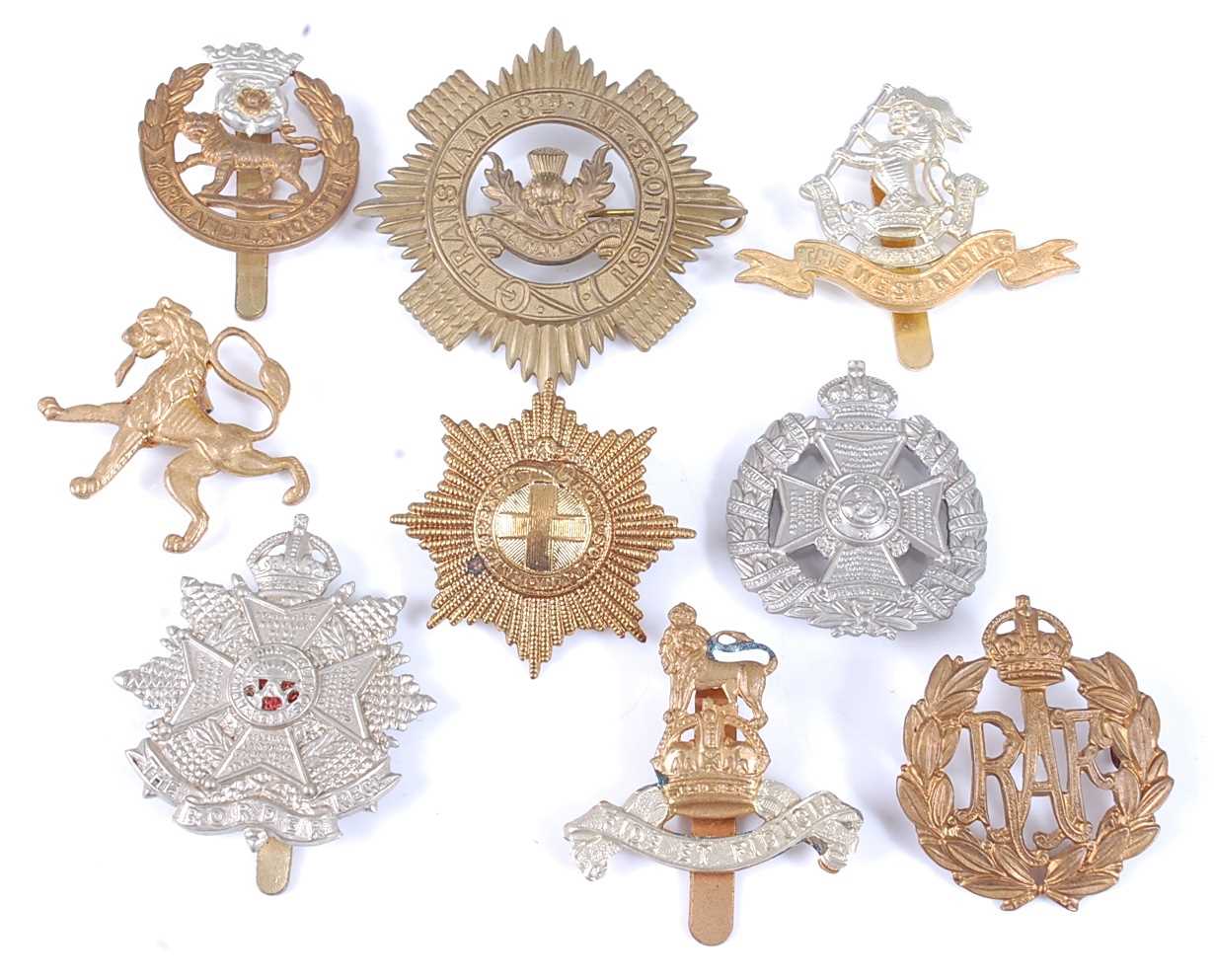 Lot 60 - A small collection of cap badges, to include...