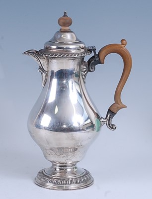 Lot 2160 - A Georgian style silver hot water pot, of pear...