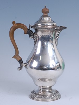 Lot 2160 - A Georgian style silver hot water pot, of pear...