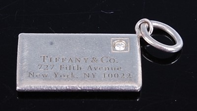 Lot 2729 - A white metal Tiffany & Co envelope charm, set...