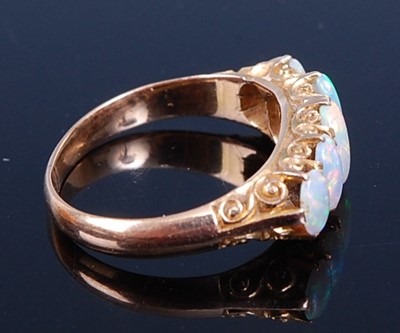 Lot 2731 - A yellow metal opal half hoop ring, comprising...