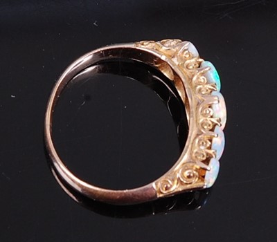 Lot 2731 - A yellow metal opal half hoop ring, comprising...