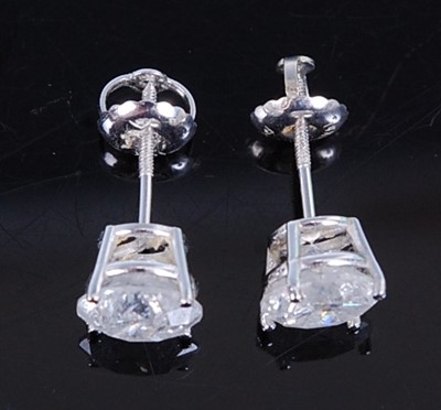 Lot 2725 - A pair of white metal diamond single stone...