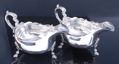 Lot 2162 - A pair of early 20th century silver sauceboats,...
