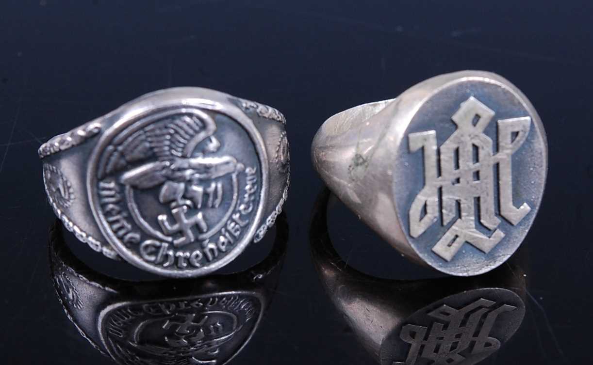 Lot 111 - A German white metal ring, embossed with an...