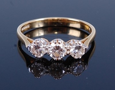 Lot 2685 - An 18ct gold diamond three-stone ring, the...