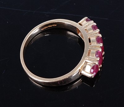 Lot 2739 - A 14ct yellow gold ruby five stone half hoop...
