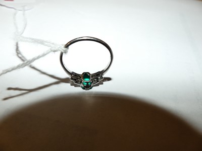 Lot 2747 - A white metal, emerald and diamond Art Deco...