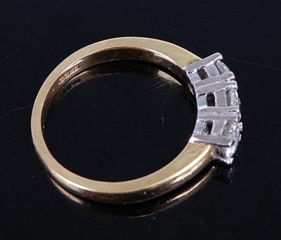 Lot 2748 - An 18ct yellow and white gold diamond trilogy...