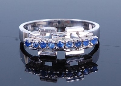 Lot 2750 - A white metal sapphire half hoop ring,...
