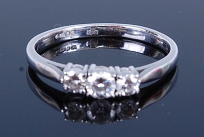 Lot 2762 - A platinum diamond three-stone ring, featuring...