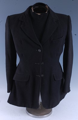 Lot 273 - A ladies hunt coat in black Melton cloth,...