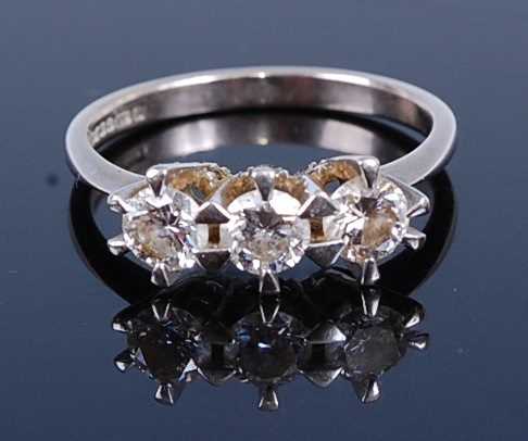 Lot 2766 - An 18ct white gold diamond trilogy ring,...