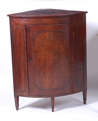 Lot 2596 - * A Regency mahogany bowfront corner cupboard,...