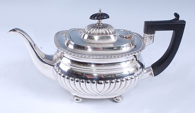 Lot 2165 - A George V silver teapot, of half-reeded oval...